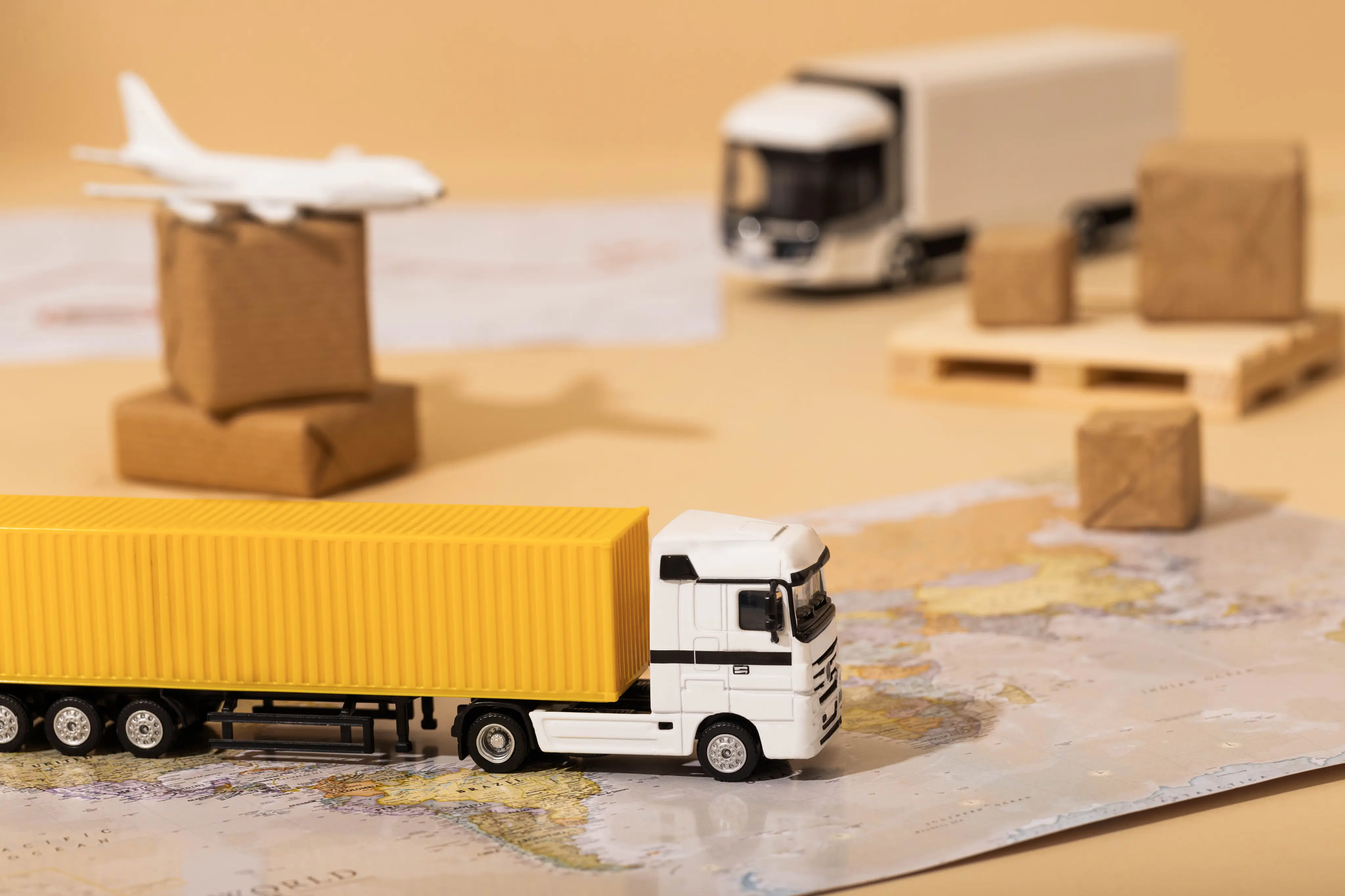 Toy truck with shipping boxes on map